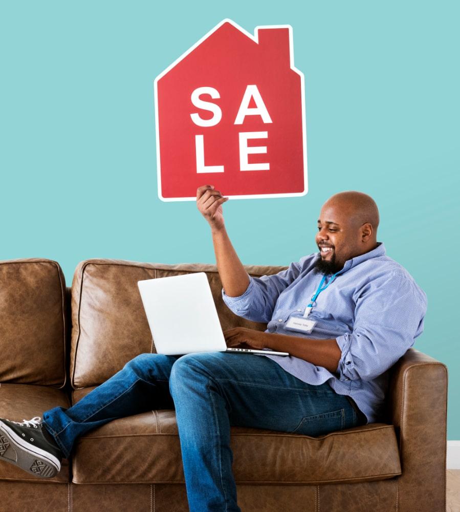 man-holding-house-sale-icon-min